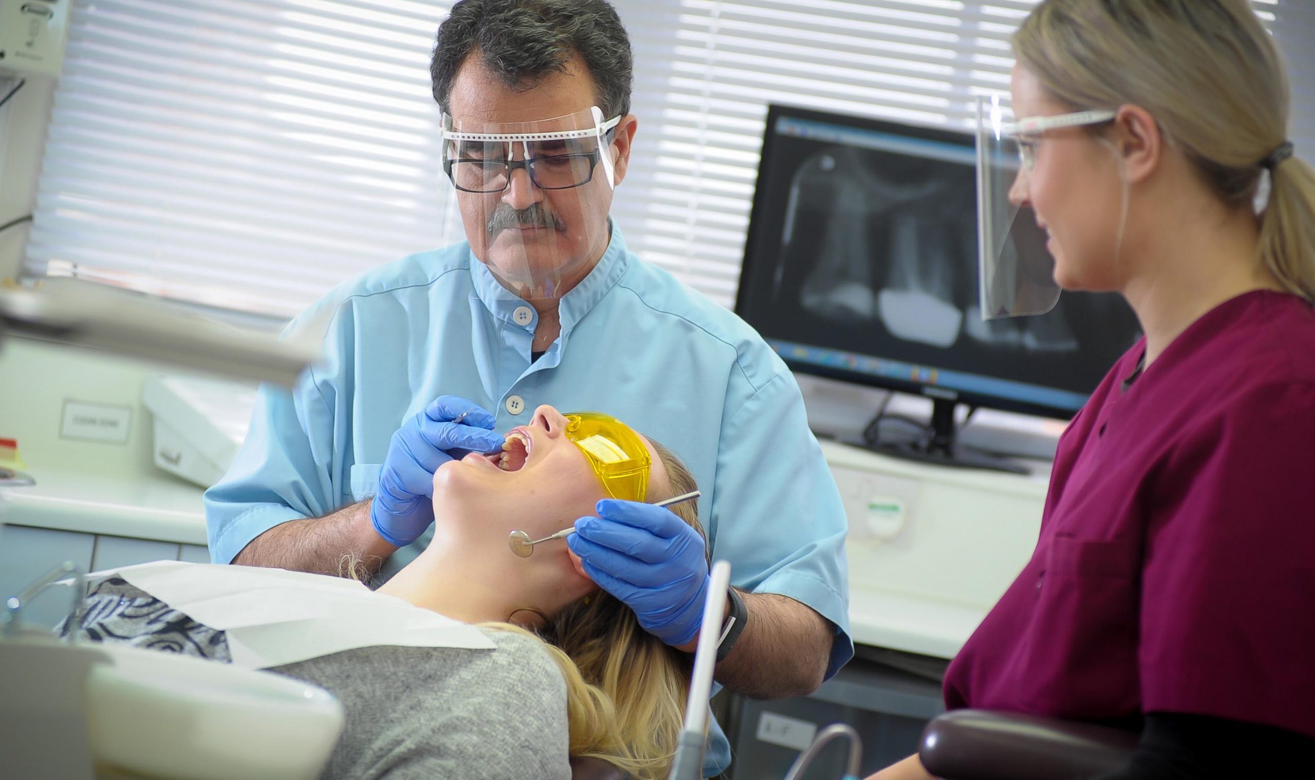 dentist and dental nurse at patient examination