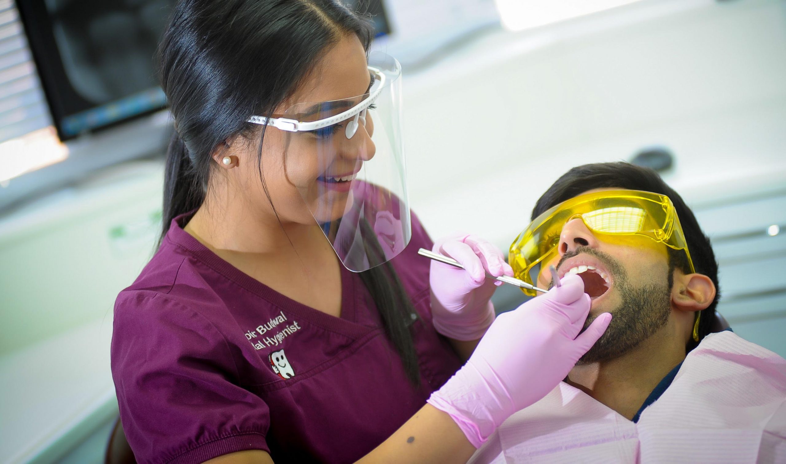 hygienist treating patient